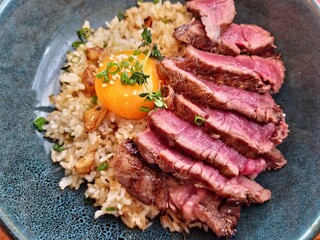 beef fat garlic fried rice with beef steak and topping with pickled egg yolk top view image 