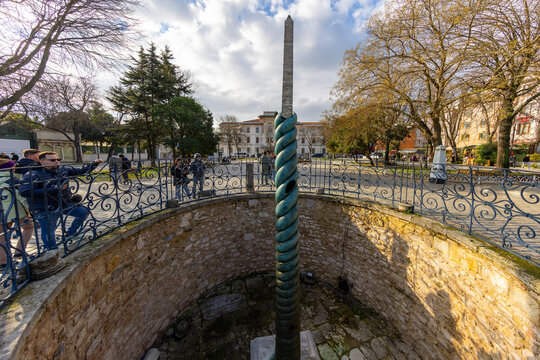 Serpentine Column (Turkish: Yilanlı Sutun) behind Ibrahim Pasha Palace at Sultanahmet Hippodrome Square on in Istanbul, Turkey.