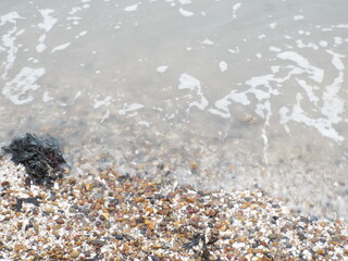 The sea and a shingle beach with the tide coming in waves