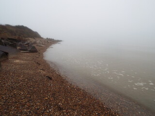 The sea and a shingle beach with the tide coming in waves