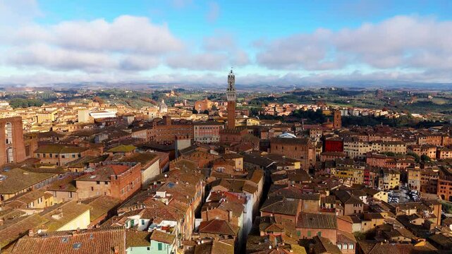 Siena's historic skyline with Torre del Mangia and cathedral under a bright sunny sky