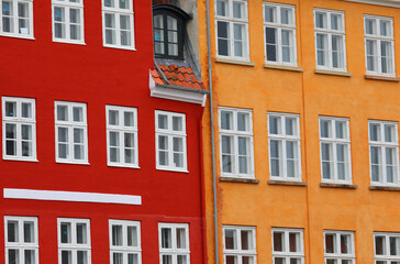 Fototapeta premium red and orange building with wooden framed windows typical of Scandinavian areas in Europe