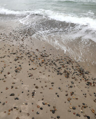 Sea shore with rocks being buried by sand and wind