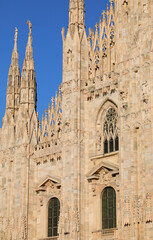 Detail of the facade of Milan Cathedral in Italy with the gothic spires and statues