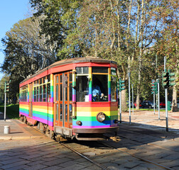 Naklejka premium electric tram on rails in vintage style colored with rainbow colors in the cityvintage tram on rails in the metropolis