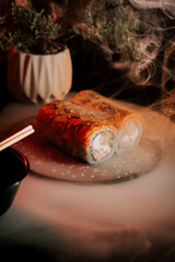 Fresh Sushi Served on a Dark Background With Steam Rising From Delicate Rolls and Chopsticks Nearby