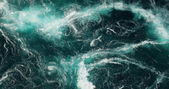 Blue waves of water of the river and the sea meet each other during high tide and low tide.