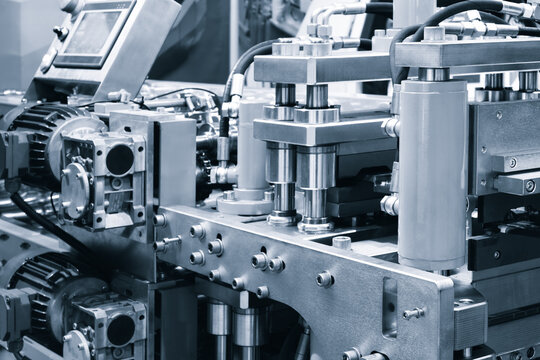 Metal sheet forming machine at the modern metalwork factory, coil sheet bending machine and automation