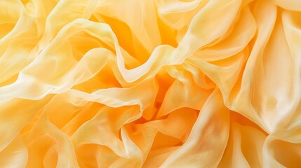 Obraz premium Soft, flowing fabric in warm yellow tones.
