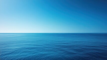 Fototapeta premium Ocean view under vast clear blue sky with gradient towards horizon