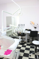 Dental office with a patient chair and medical equipment for dental treatment.