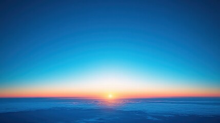 Obraz premium Expansive blue sky at sunrise with golden light