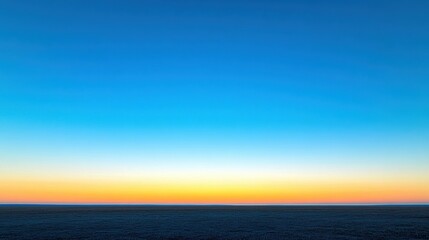 Obraz premium Clear blue sky at golden sunrise with endless horizon