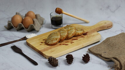 Serabi Dish with Honey Drizzle on Wooden Board