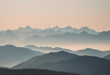 Fototapeta premium Mountain range covered in fog, towering above tree tops, creating a mystical. 