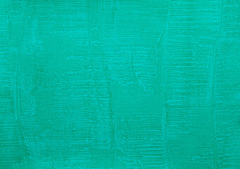 Teal color textured wall surface. Close up of grunge background with green color texture.