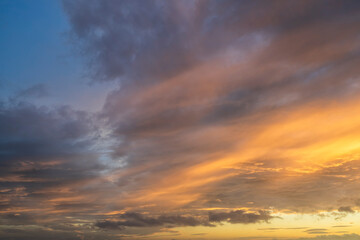Fototapeta premium Glowing real sky at sunset texture background overlay. Dramatic red and orange clouds.