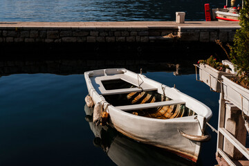 Obraz premium small boats tightened at berth on quee in Perast , Montenegro, tranquility moment