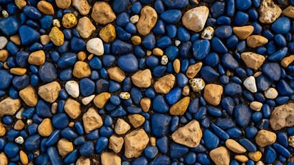 Texture composed of the dry soil surface in dark blue tones with small gold and white stones, seen from above. Good for abstract dark blue background. floor