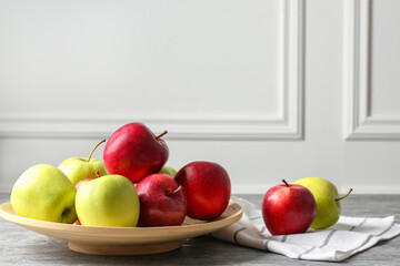 Fresh red and green apples on grey table