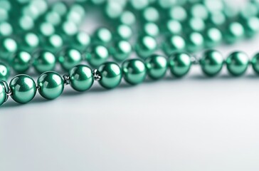 Elegant Green Pearls on a Soft Background, Glimmering and Reflecting Light, Ideal for Jewelry, Fashion, or Decorative Themes in High-Quality Photography.