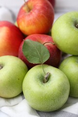Different whole ripe apples on towel, closeup