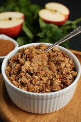 Delicious apple crisp in bowl on table, closeup