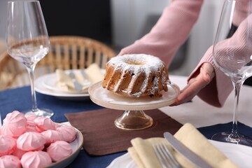 Woman setting table for dinner at home, closeup