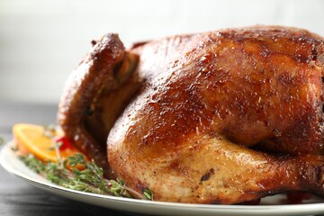 Delicious baked turkey and thyme on table, closeup
