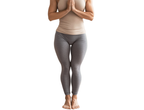 A person practicing yoga in a standing tree pose, hands together in a prayer position, centered on a white background with a balanced and serene look