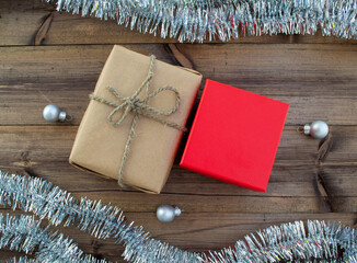 Christmas background. Christmas gifts, Christmas balls, tinsel on a wooden background.
