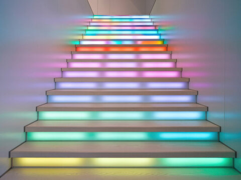 Interior con una escalera LED &uacute;nica. La escalera LED tiene varios escalones y cada escal&oacute;n tiene un color diferente
