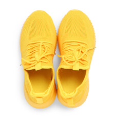 Pair of stylish yellow sneakers isolated on white, top view