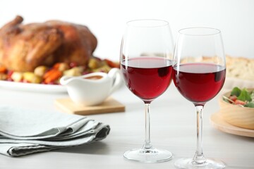 Red wine and delicious dinner served on light table