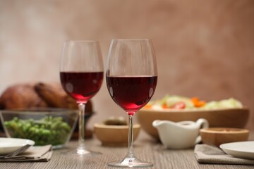 Red wine and delicious dinner served on wooden table