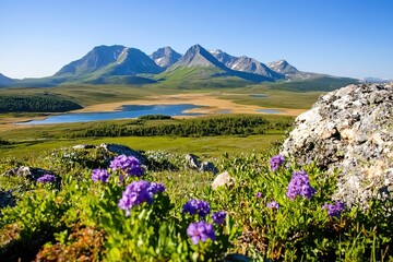 Obraz premium Scenic Mountain View with Vibrant Wildflowers and Serene Lake in the Background