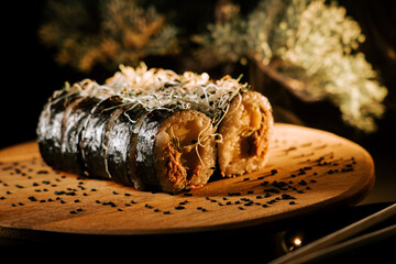 Exquisite Sushi Roll Displayed on a Wooden Board With Artistic Garnishing Under Soft Lighting