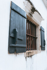 Window with shutters and bars in a building in Macau