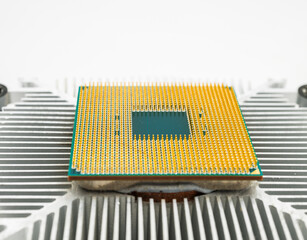 Pin side of a CPU processor mounted on a cooler.