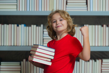 Successful school boy. Little student on school library. Child reading book at school. Nerd pupil...