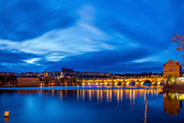 Panoramic view of Prague Castle and St. Vitus Cathedral over the Vltava River in Prague, Czech Republic.