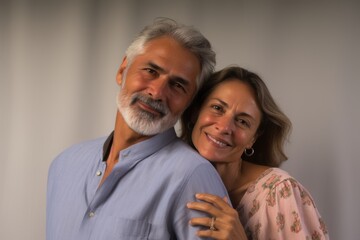 A man and a woman are smiling at the camera