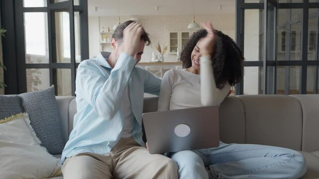 Happy Mixed Race Young Couple Using Laptop Recieved Unbelievable Good News