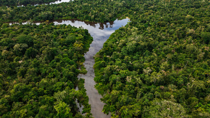 AERIAL PHOTOS OF THE NANAY RIVER AND BOATS NAVIGATING IN ITS WATERS, IN THE PERUVIAN AMAZON JUNGLE, BLACK WATER IGAPO WITH COMMUNITIES OF PEOPLE SURROUNDING THE NANAY.