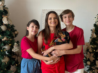 familia juntos com cachorro fofo duchshund celebrando o natal 
