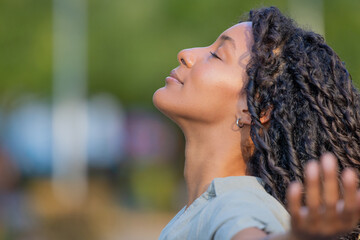 portrait of beautiful young latina woman breathing relaxed outdoors