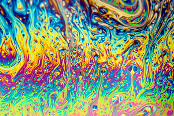 Abstract background of a Dynamic interference colors in thin soap films. Bubble rainbow colors.