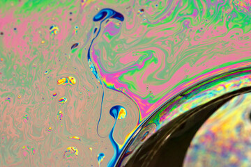 Abstract background of a Dynamic interference colors in thin soap films. Bubble rainbow colors.