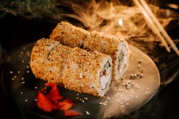 Fresh sushi with sesame and ginger on a black background. Sushi concept