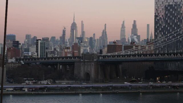 cards driving on road fdr drive in manhattan with bridge visible in the foreground nyc skyline in background during dawn sunrise (colorful sky skyscrapers buildings new york city) usa travel tourism
